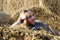 Girl in a yellow stack of hay