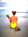 Girl in yellow swimsuit sitting on the beach in Nha Trang Vietnam Royalty Free Stock Photo