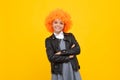 Girl with yellow wig. Funny child wearing orange curly wig hair, summer fun. Happy girl face, positive and smiling Royalty Free Stock Photo