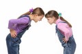 Girl yells at younger sister during altercation on white background Royalty Free Stock Photo