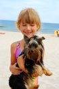 Girl with yorkshire dog on the beach Royalty Free Stock Photo