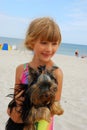 Girl with yorkshire dog on the beach Royalty Free Stock Photo