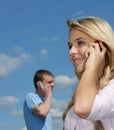 Girl and young man speak by a mobile phone Royalty Free Stock Photo