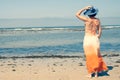 Girl young standing looking at the sea with beach hat rear back view Royalty Free Stock Photo