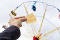 Girl or young woman holding amusement park tickets in hand.