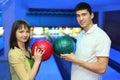 Girl and youth turned to each other with balls