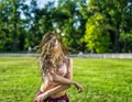 Girl with zizi cornrows dreadlocks dancing on lawn Royalty Free Stock Photo