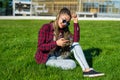 Girl with zizi cornrows dreads chatting on her smartphone