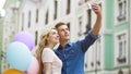 Girlfriend and boyfriend hugging in street and taking selfie, romantic photos Royalty Free Stock Photo