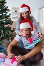 The girlfriend and boyfriend opening christmas gifts Royalty Free Stock Photo