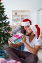 The girlfriend and boyfriend opening christmas gifts Royalty Free Stock Photo