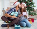 Girlfriend and boyfriend opening christmas gifts Royalty Free Stock Photo