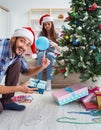 Girlfriend and boyfriend opening christmas gifts Royalty Free Stock Photo