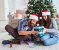 Girlfriend and boyfriend opening christmas gifts Royalty Free Stock Photo