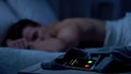 Girlfriend calling while male sleeping deeply and missing call, business trip Royalty Free Stock Photo