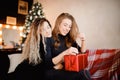 Girlfriend girls give New Year gift in boxes, hug and smile. Concept sisterhood