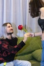 Girlfriend giving a rose to her boyfriend at home Royalty Free Stock Photo