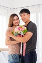 The girlfriend is glad to recieve a bouquet of flowers from her boyfriend.