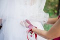Girlfriend helps the bride get dressed