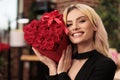 Girlfriend holding red roses bouquet celebrating love holiday Royalty Free Stock Photo