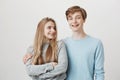 Girlfriend knows boyfriend prepared something for anniversary. Portrait of two friendly caring siblings, hugging and Royalty Free Stock Photo