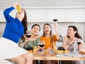 Girlfriends chatting and drinking wine in kitchen Royalty Free Stock Photo