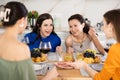 Girlfriends chatting and drinking wine in kitchen Royalty Free Stock Photo