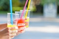 Girlfriends enjoying cocktails in an outdoor cafe, hands detail shot