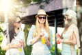 Girlfriends enjoying cocktails by a water fountain Royalty Free Stock Photo