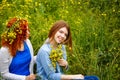 Girlfriends with flowers in park.