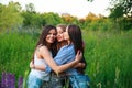 Girlfriends Friendship Happiness Community Concept. Three smiling friends hugging outdoors in the nature