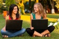 Girlfriends with laptops sitting