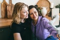 Girlfriends laugh merrily and take selfies in the kitchen. Royalty Free Stock Photo