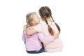 Girlfriends in pink sweaters and jeans are hugging and laughing. Back view. Isolated over white background