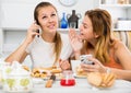 Girlfriends are playfull talking by phone