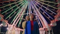 Girlfriends posing ferris wheel at night. Two models resting illuminated funfair Royalty Free Stock Photo