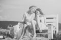 Girlfriends rest. Two girls sitting on bench on hay Royalty Free Stock Photo