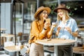 Girlfriends spending time together on a cafe terrace Royalty Free Stock Photo