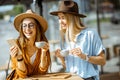 Girlfriends spending time together on a cafe terrace Royalty Free Stock Photo