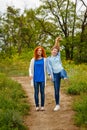 Girlfriends standing on a footpath