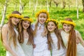 Girlfriends are standing with wreaths of dandelions on their heads in the open air Royalty Free Stock Photo