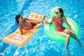 Girlfriends sunbathing on air mattress and drinking cocktails Royalty Free Stock Photo