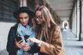 Girlfriends tourist using together smartphone mobile. Blogger hipster travels in europe city. Holiday friendship concept. Traveler