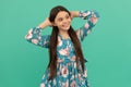 Girlhood dream. Relaxed girl blue background. Happy child smile putting hands behind head. Girlhood Royalty Free Stock Photo