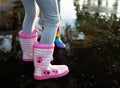 Girlie striped wellingtons in the puddle Royalty Free Stock Photo