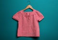 Girlish blouse with hanger on color background