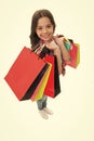 Girlish happiness. Kid girl happy smiling face carries bunch packages white background. Birthday girl concept. Girl