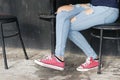 Girlish legs in torn jeans