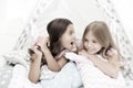 Girlish leisure. Sisters share gossips having fun at home. Pajamas party for kids. Cozy place tipi house. Sisters or Royalty Free Stock Photo