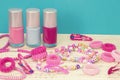 Girlish teenager room, place for makeup at home. A group of colorful Nail Polish bottles, hair ribbons, bracelets, necklaces, hair